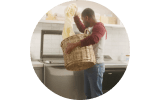 A person loads laundry into a Whirlpool® Washing Machine