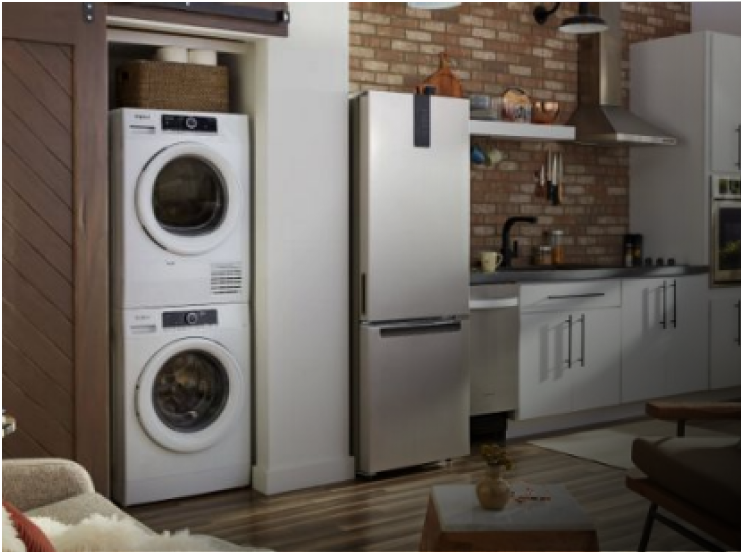 A kitchen with light cabinets and small space appliances