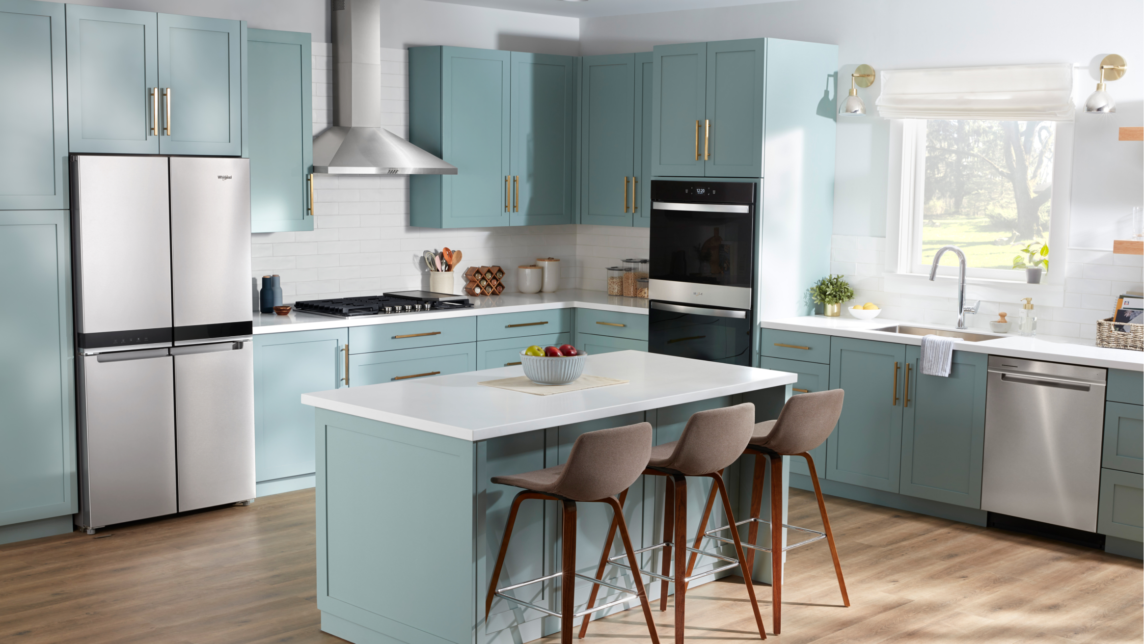 Whirlpool® appliances in a kitchen with light blue cabinets and an island