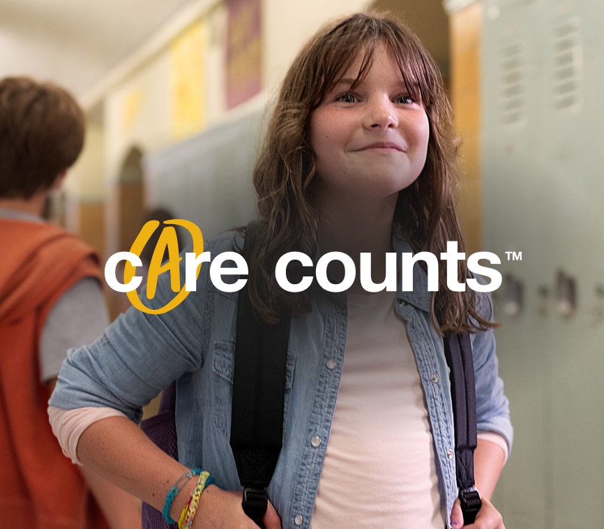 A girl in school with the Care Counts logo on the image