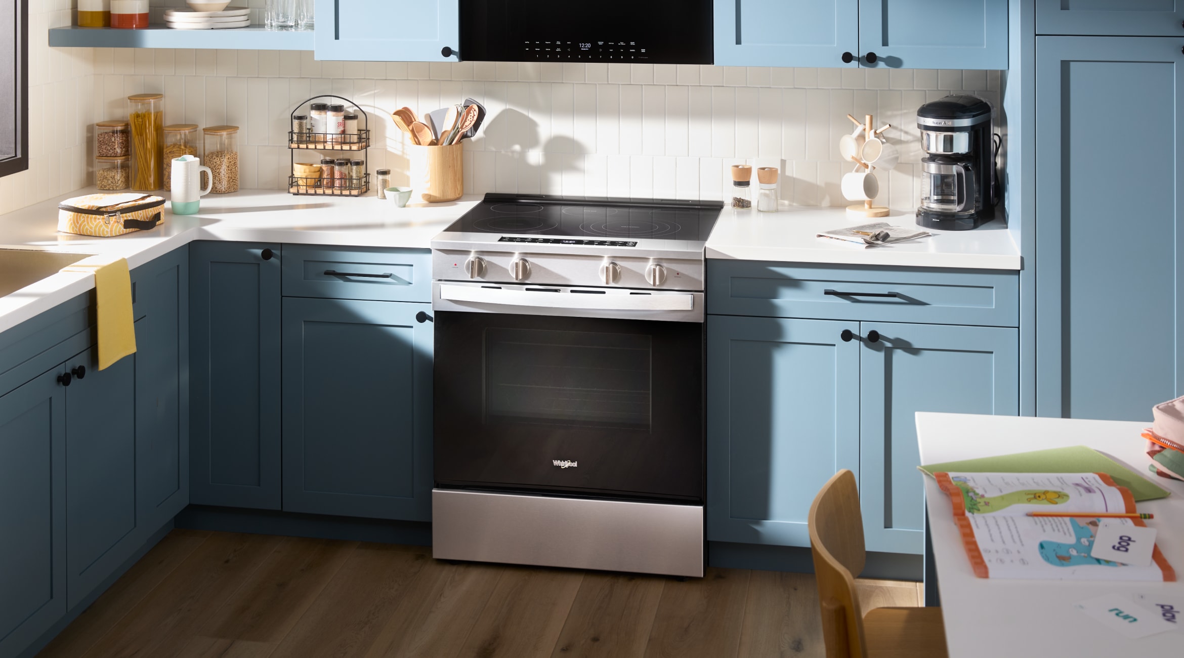 A Whirlpool® Premiun Slide-In Range in a kitchen with blue cabinets