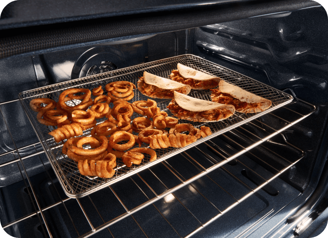 Curly fries and quesadillas being air fried in the oven