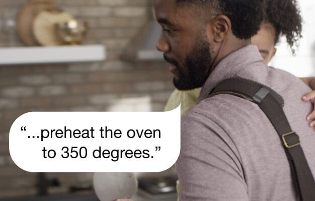 Father using voice control while holding daughter