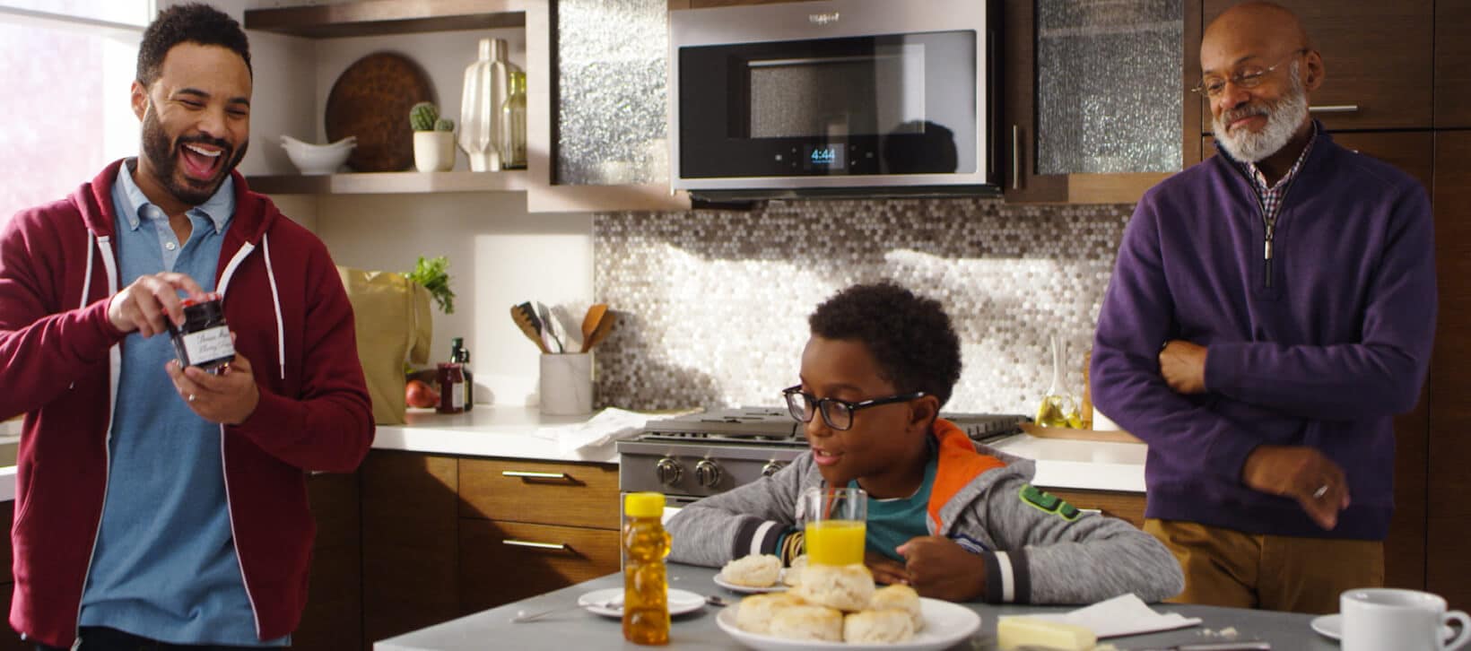 Multi-generational family preparing biscuits in the kitchen.