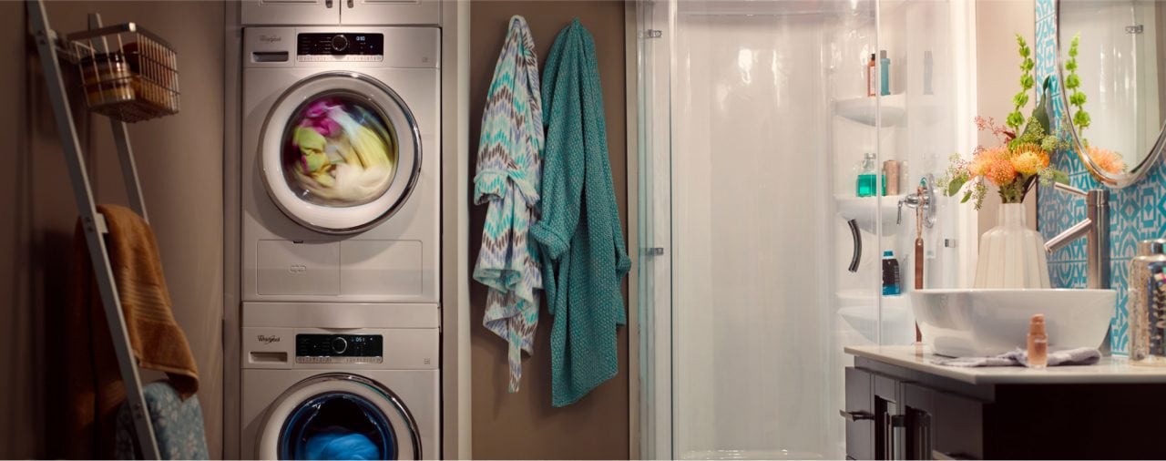 A Whirlpool® front load laundry set stacked in a bathroom. A Whirlpool® front load laundry set stacked in a bathroom.
