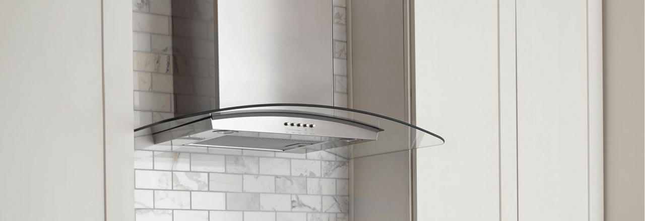 A Whirlpool® vent hood prominently displayed in a kitchen. A Whirlpool® vent hood prominently displayed in a kitchen.