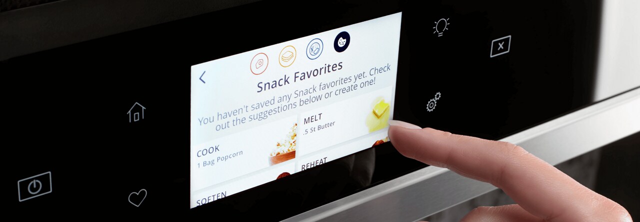 A hand selecting cooking settings on a smart microwave touch screen. A hand selecting cooking settings on a smart microwave touch screen.