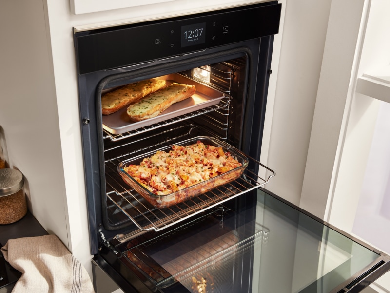 Casserole and garlic bread cooking inside a Whirlpool® wall oven Casserole and garlic bread cooking inside a Whirlpool® wall oven