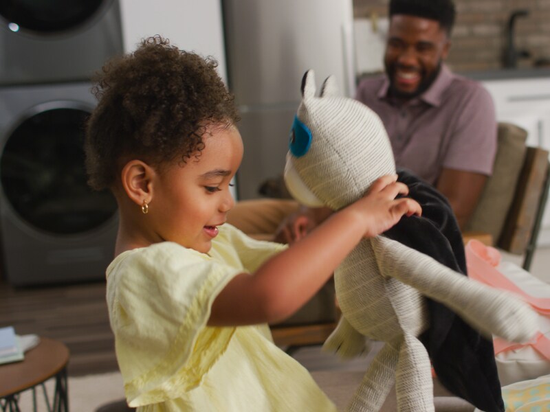 Child playing with a stuffed toy Child playing with a stuffed toy