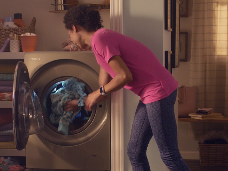 Person removing clothes from a dryer Person removing clothes from a dryer