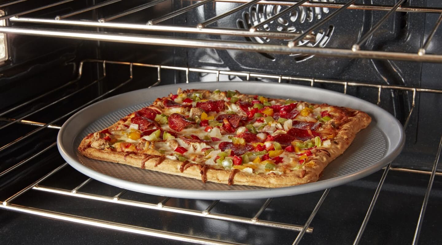 A square pizza cooking in a convection oven A square pizza cooking in a convection oven