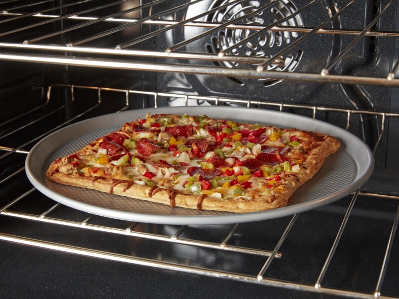 A square pizza cooking in a convection oven A square pizza cooking in a convection oven