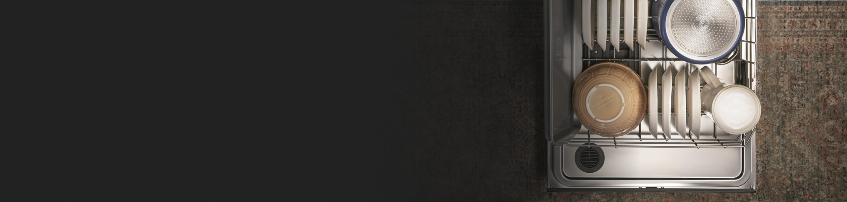 Open dishwasher filled with bowls and dishes