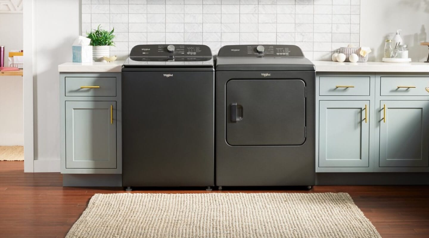 Gray Whirlpool® Top Load Washer and Dryer pair in light blue cabinetry