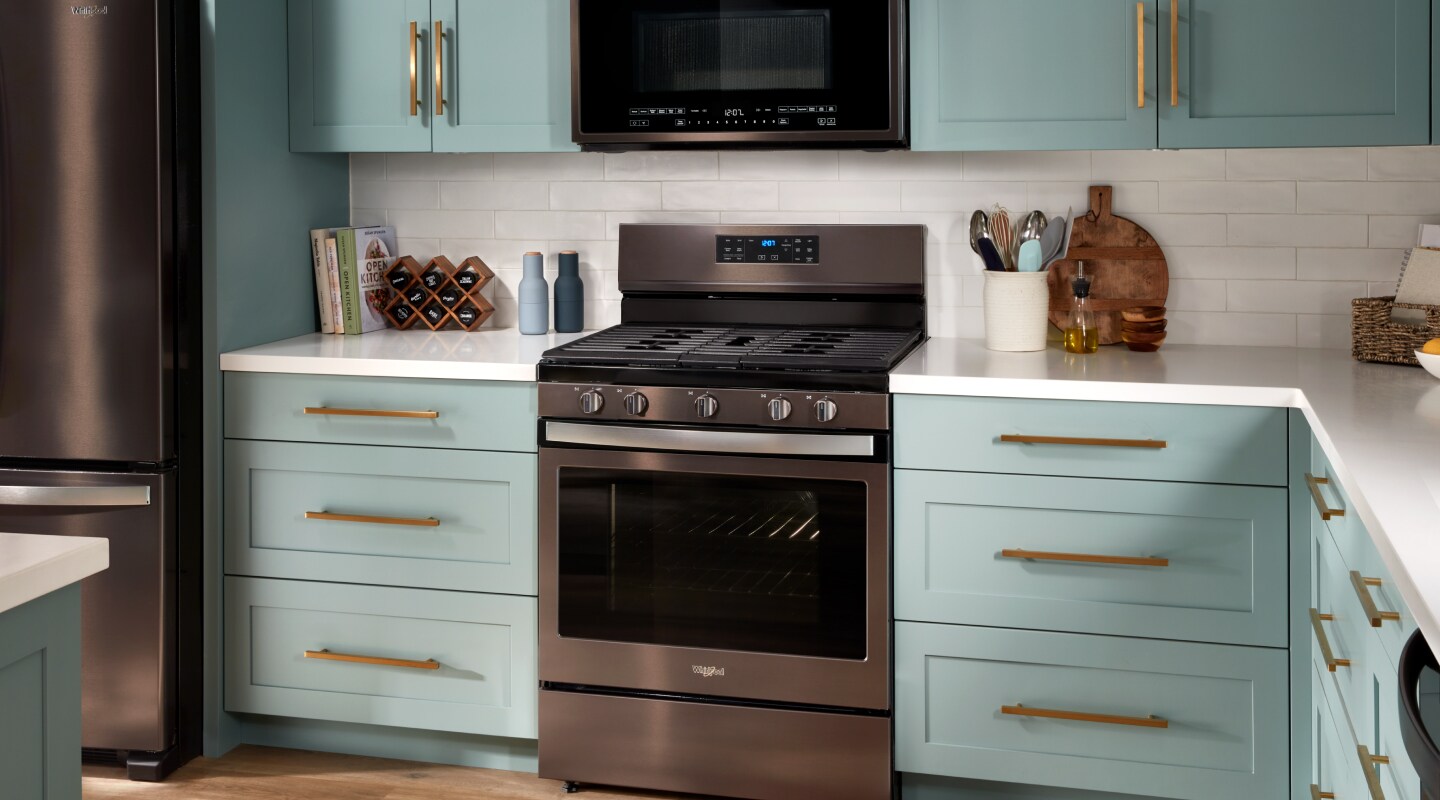 Stainless steel range surrounded by blue cabinets Stainless steel range surrounded by blue cabinets