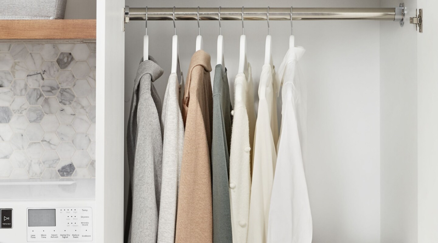 Clothing hung inside a closet Clothing hung inside a closet