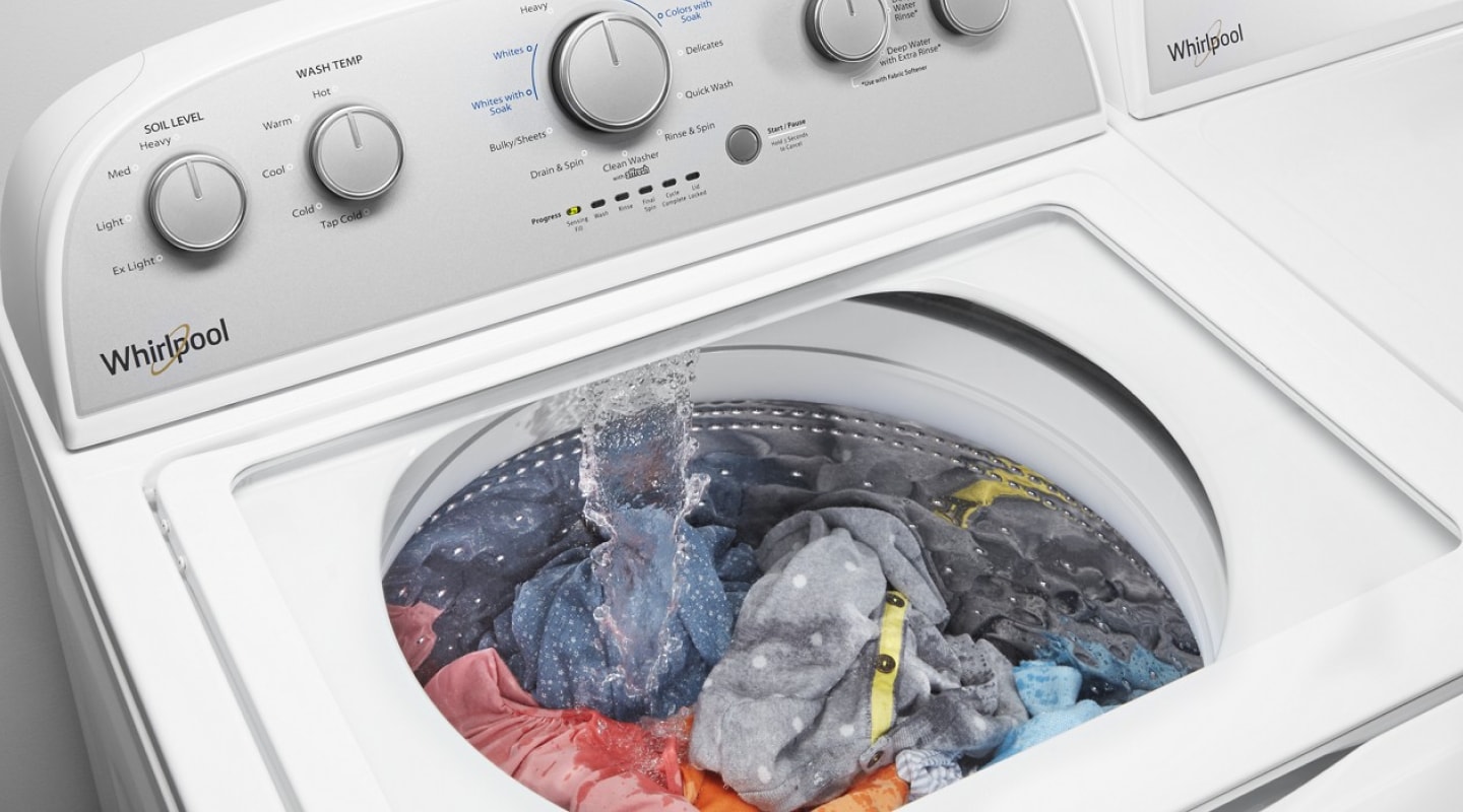 Clothes inside a running washing machine Clothes inside a running washing machine