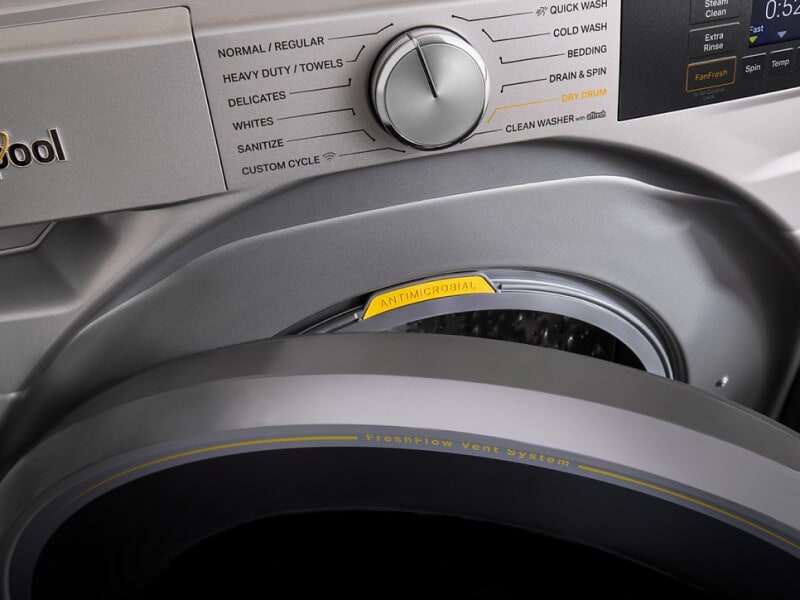 Close up of a front load washer with the door slightly open Close up of a front load washer with the door slightly open