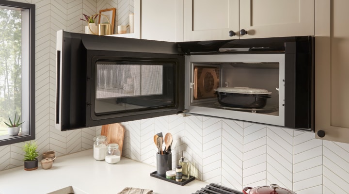 Food in an over-the-range microwave with the door open Food in an over-the-range microwave with the door open