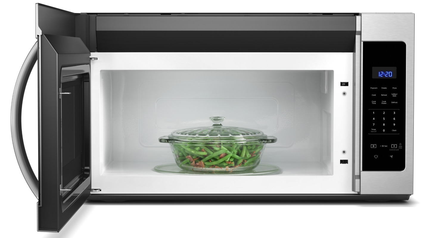 Casserole dish of green beans inside a microwave Casserole dish of green beans inside a microwave