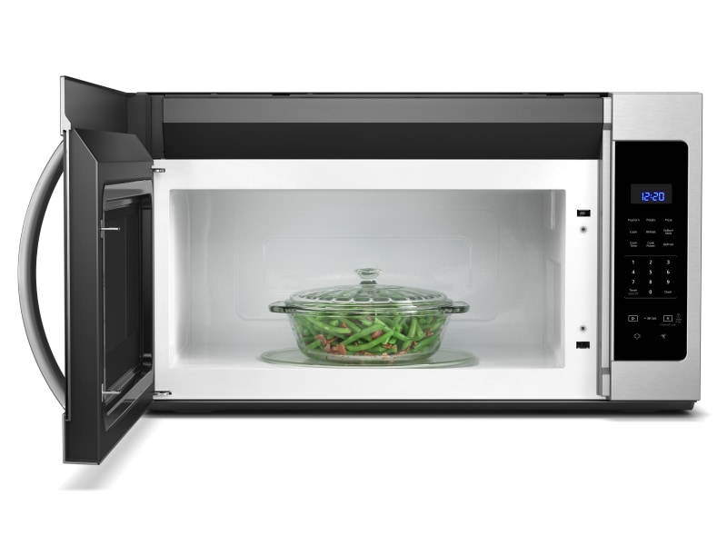 Casserole dish of green beans inside a microwave Casserole dish of green beans inside a microwave