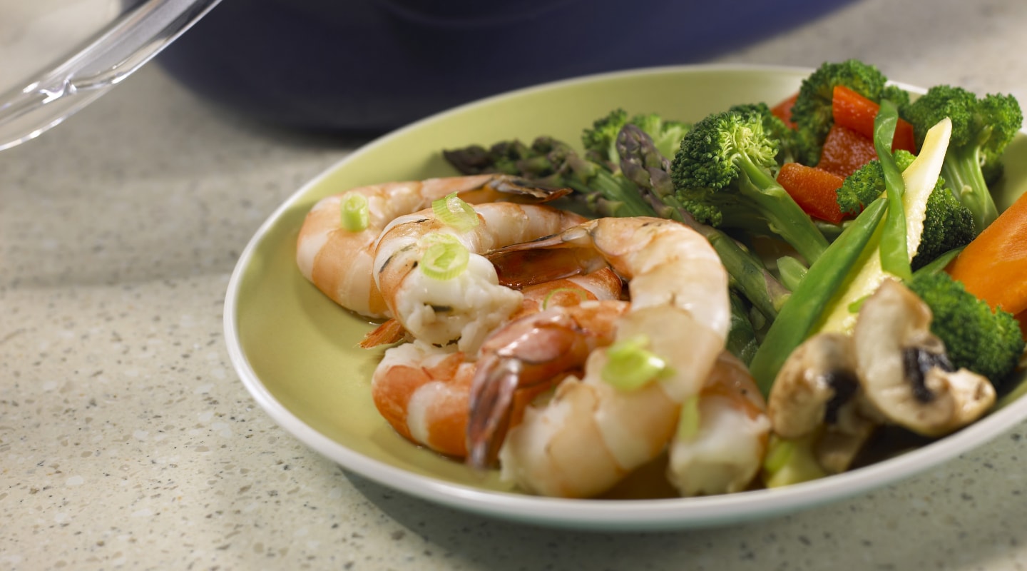 Steamed vegetables on a plate with grilled shrimp Steamed vegetables on a plate with grilled shrimp