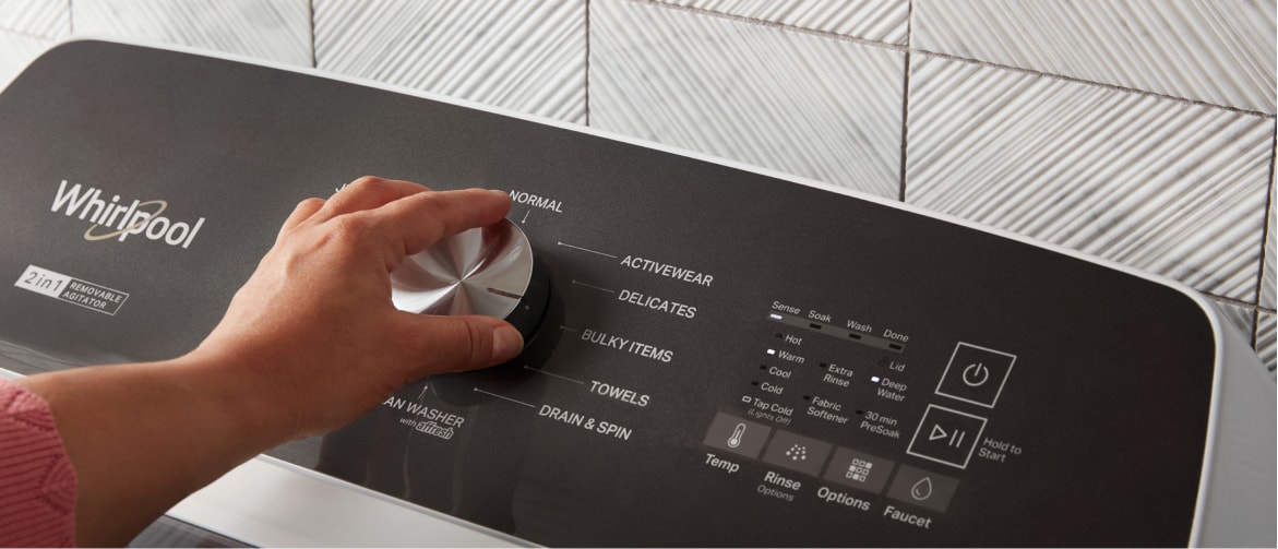 Hand turning the knob on a Whirlpool® Top Load Washer Hand turning the knob on a Whirlpool® Top Load Washer