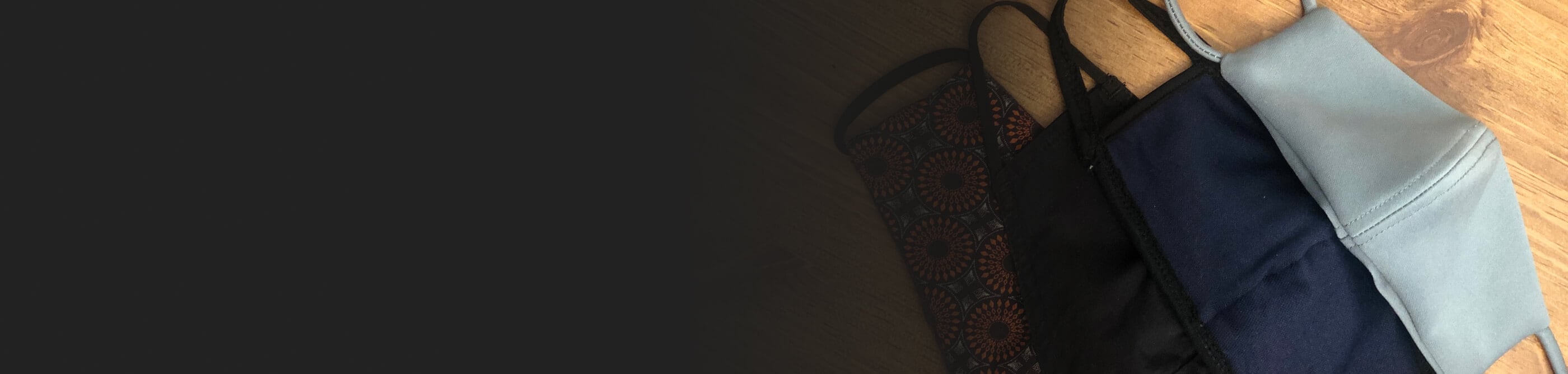 Cloth face masks on a wood background