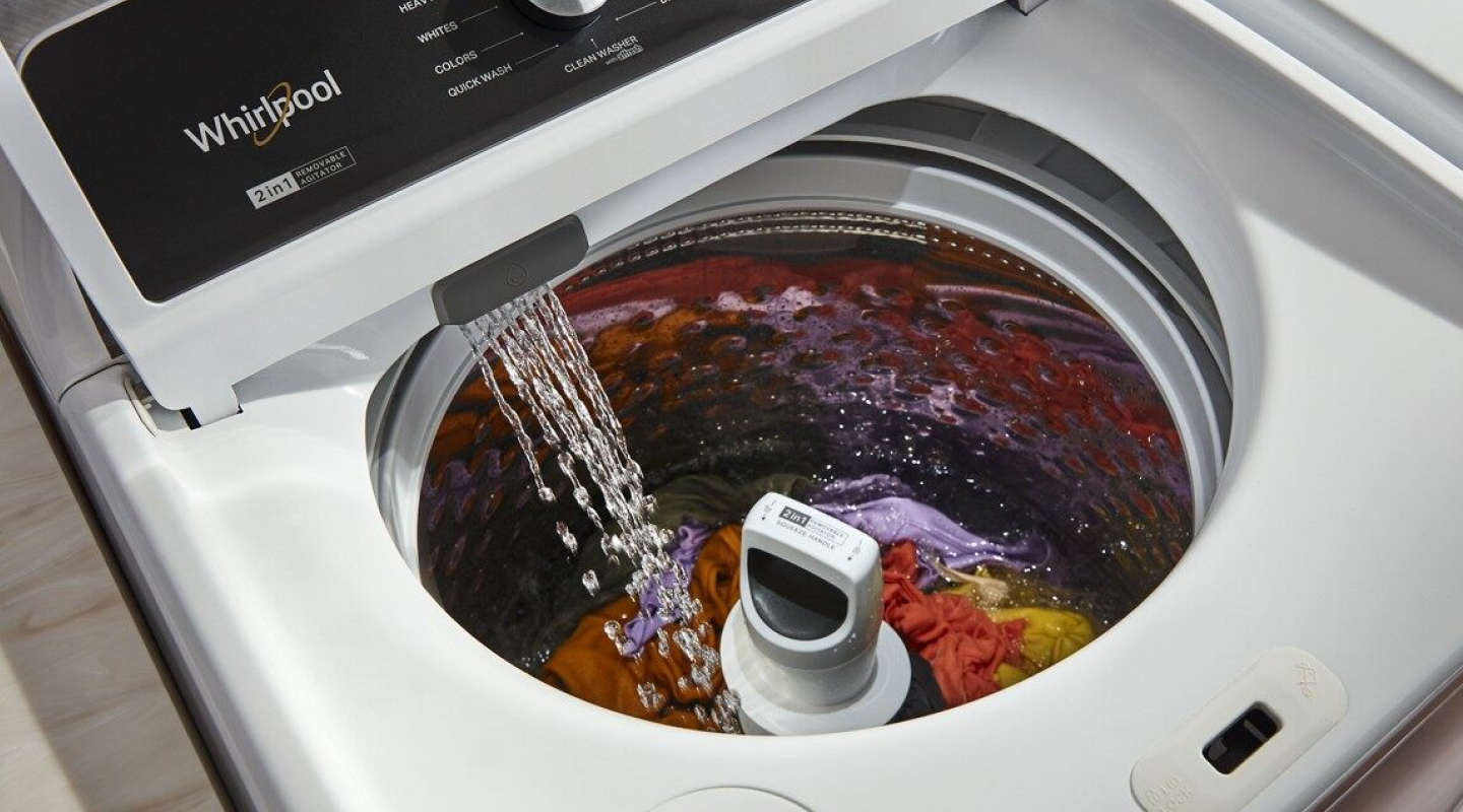 A closeup of a Whirlpool® top load washing machine filling with water. A closeup of a Whirlpool® top load washing machine filling with water.