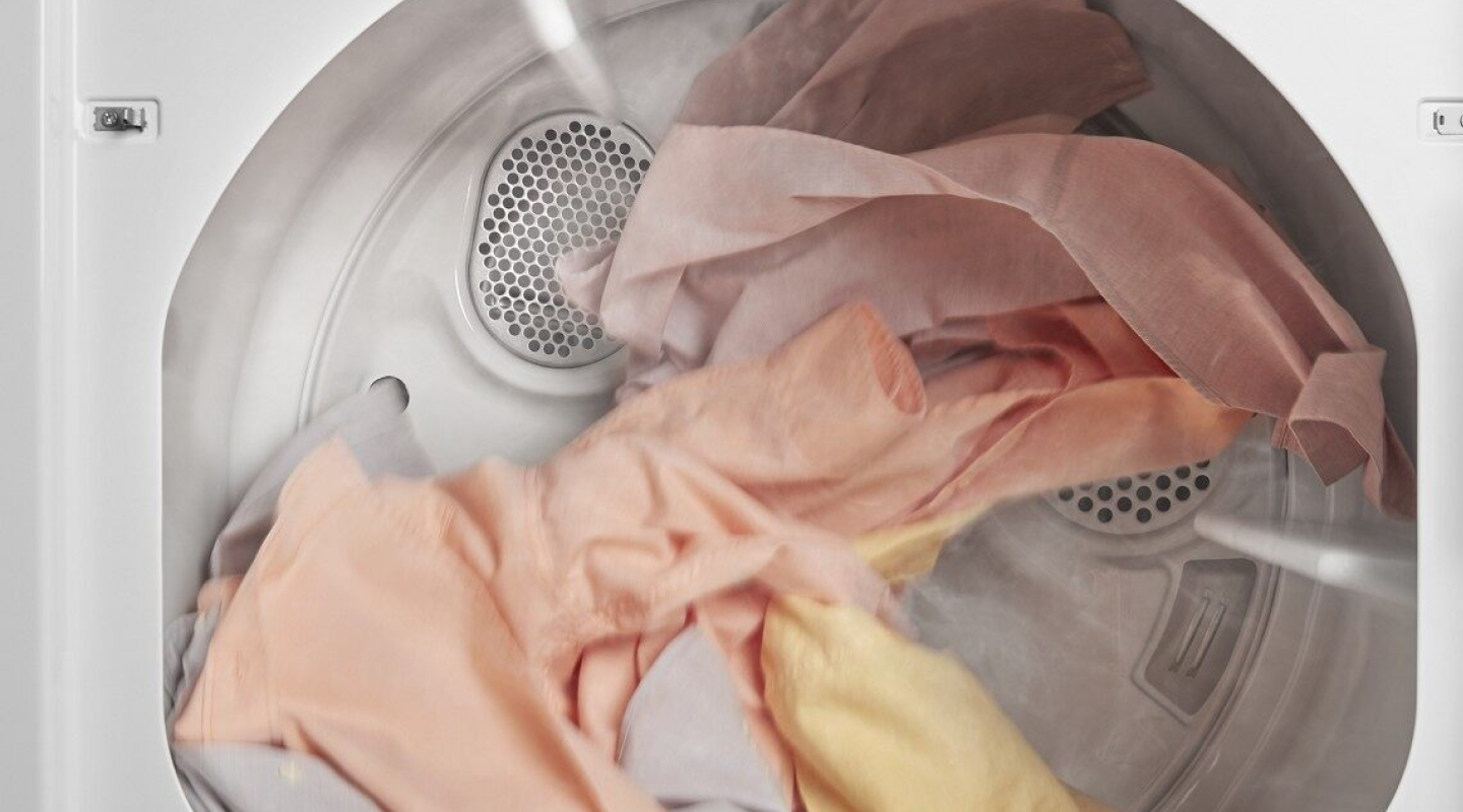 A closeup of laundry tumble drying in a Whirlpool® dryer. A closeup of laundry tumble drying in a Whirlpool® dryer.