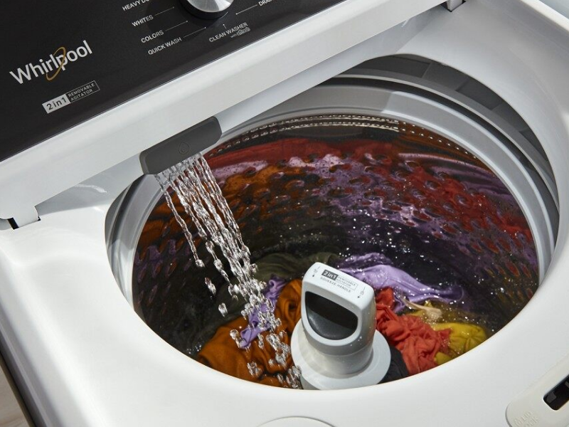 A closeup of a Whirlpool® top load washing machine filling with water. A closeup of a Whirlpool® top load washing machine filling with water.