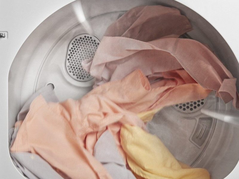 A closeup of laundry tumble drying in a Whirlpool® dryer. A closeup of laundry tumble drying in a Whirlpool® dryer.
