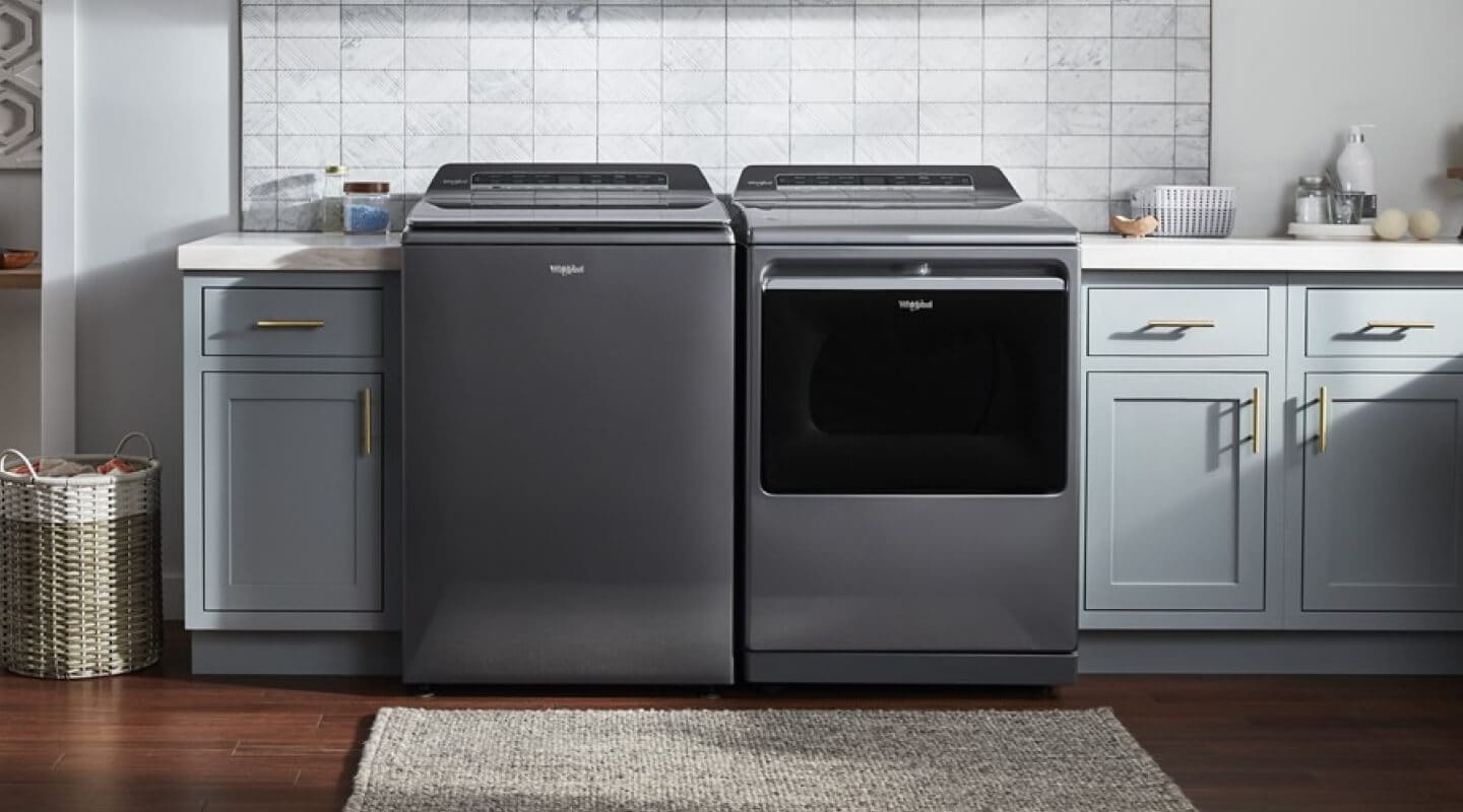 Gray Whirlpool®  Top Load Washer and Dryer pair in blue cabinetry