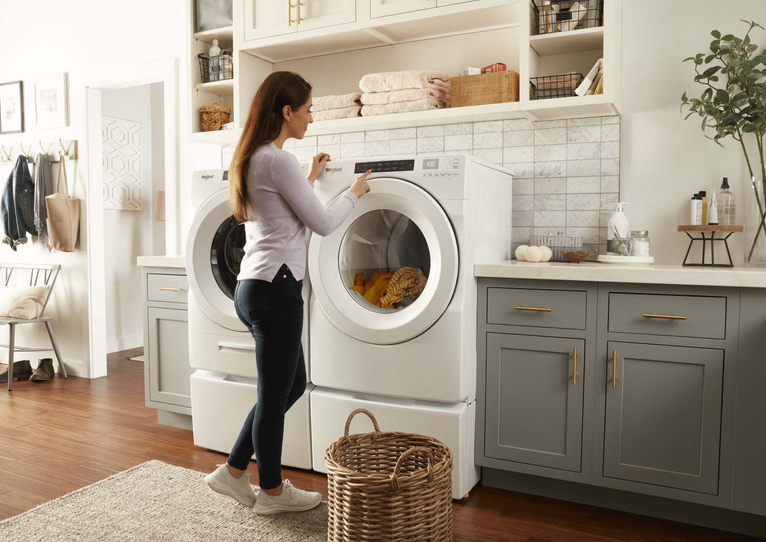 Woman starting a dryer cycle
