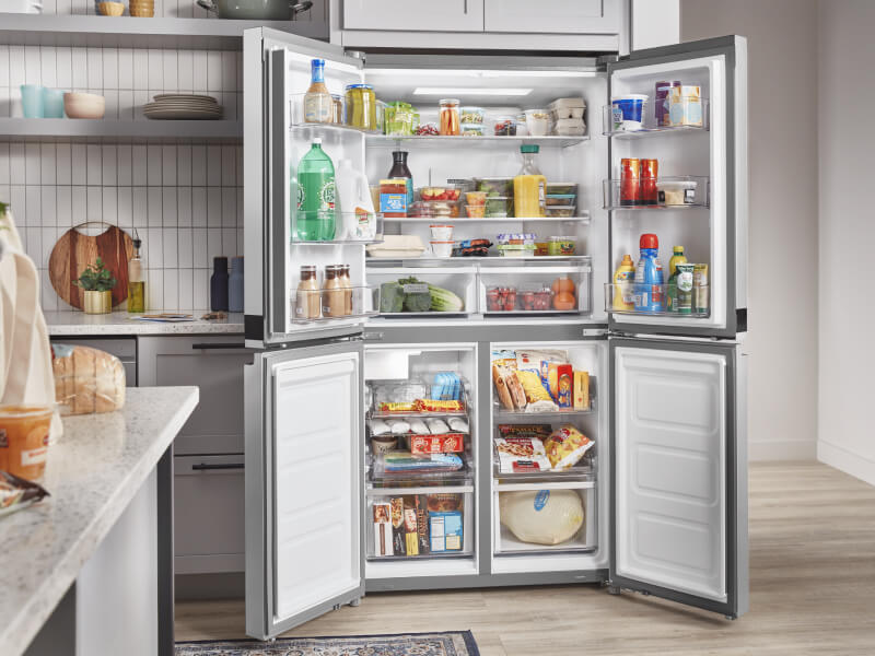 Open four door refrigerator full of groceries Open four door refrigerator full of groceries