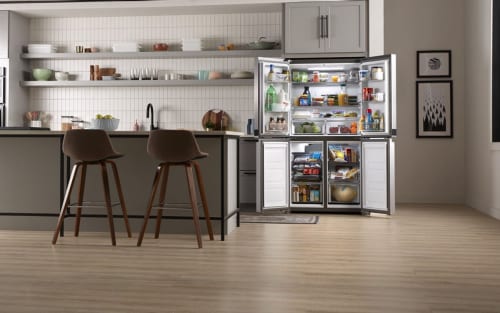 Open Whirlpool® 4-Door Refrigerator stocked with food in open-concept kitchen