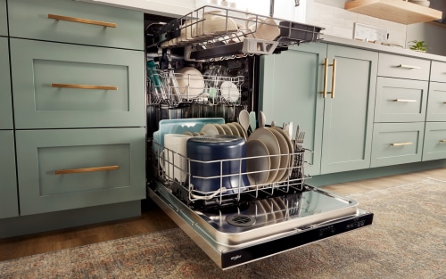 Open dishwasher filled with dishes