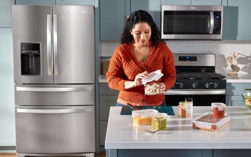 Woman opening a container in her kitchen