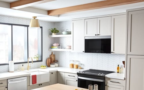 Whirlpool® Over-the-Range Microwave above electric range in white cabinetry