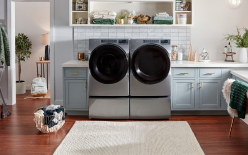 Whirlpool® Front Load Washer and Dryer pair on pedestals in a laundry room